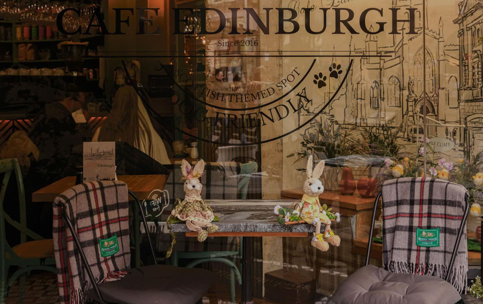 Candlelit interior of Cafe Edinburgh with walnut floors and leather banquettes